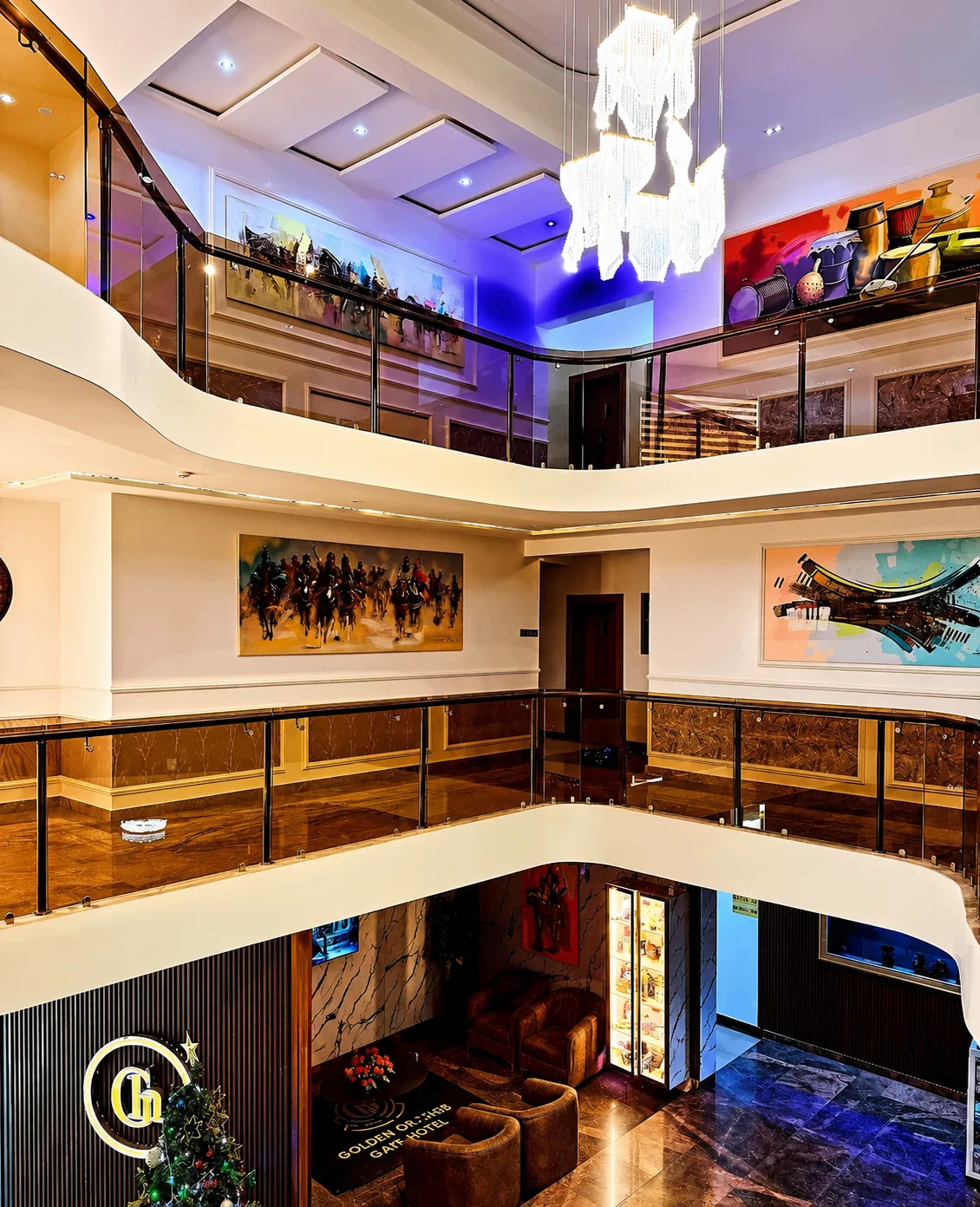 Grand multi-level lobby with chandelier and gallery-style artwork
